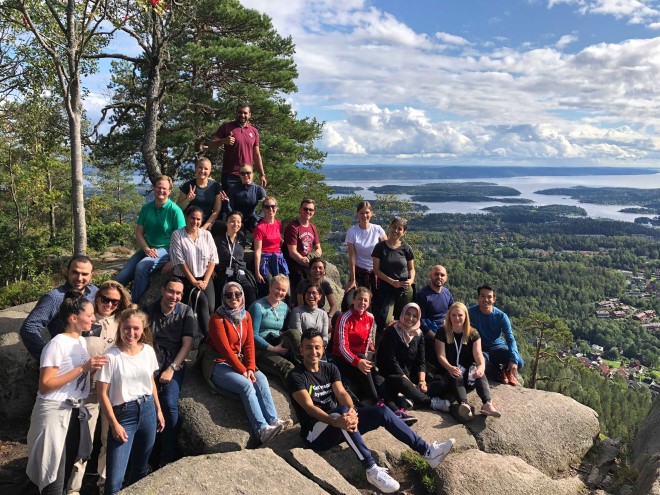 NYSCO participants on a hilltop with view over the fjord