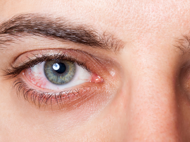 a close-up of an eye, blue with a dark eye brow