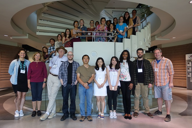 group picture of about 30 researchers lined up in a spiral staircase
